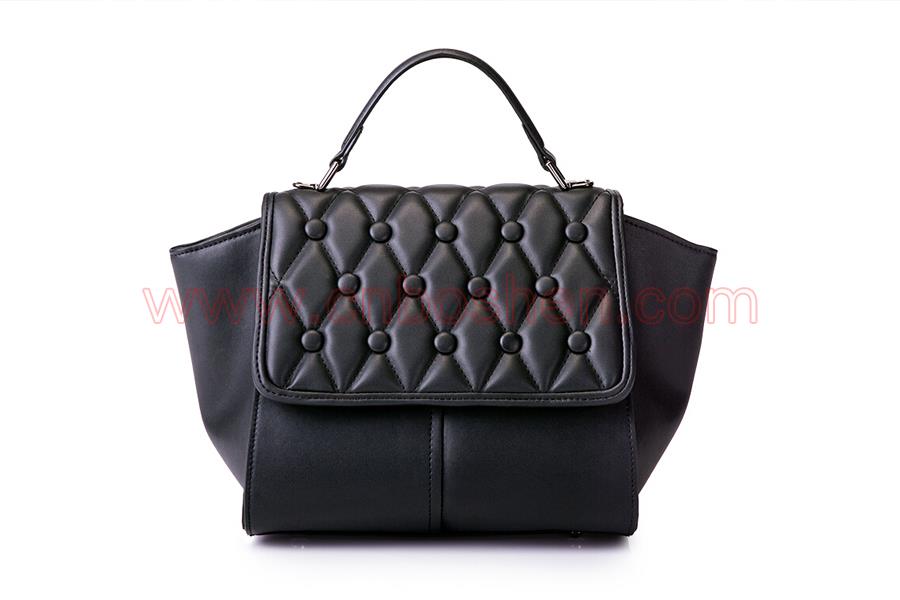 What is the cost for a leather goods manufacturer to make a handbag?